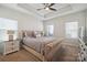 A beautifully appointed main bedroom with a tray ceiling, soft lighting, and neutral color tones at 6242 Ashton Park Dr, Denver, NC 28037