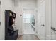 Mudroom featuring a bench, coat rack, and access to the laundry room, offers practical storage solutions at 6242 Ashton Park Dr, Denver, NC 28037