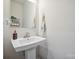 Bright powder room with pedestal sink and decorative accents at 6242 Ashton Park Dr, Denver, NC 28037