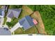 Aerial view of home featuring a long driveway, well-maintained lawn, and a fenced backyard with mature trees, showcasing its privacy at 6808 Squirrels Foot Ct, Charlotte, NC 28217