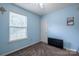 This is a cozy blue bedroom with carpet, a window, and a ceiling fan at 6808 Squirrels Foot Ct, Charlotte, NC 28217
