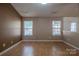 Bright bedroom features hardwood flooring and windows, offering natural light at 6808 Squirrels Foot Ct, Charlotte, NC 28217