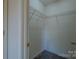 Walk-in closet features built-in shelving providing ample storage space at 6808 Squirrels Foot Ct, Charlotte, NC 28217