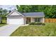 Charming single-story home with a well-maintained lawn, garage, and inviting front porch at 6808 Squirrels Foot Ct, Charlotte, NC 28217