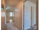 Hallway view showcasing tiled flooring, neutral walls, and an open doorway to living area at 6808 Squirrels Foot Ct, Charlotte, NC 28217