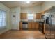 Galley-style kitchen with stainless steel appliances, granite countertops, and light wood cabinets at 6808 Squirrels Foot Ct, Charlotte, NC 28217