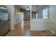 View from kitchen showing the living area with vaulted ceiling, adjacent rooms, and laminate floor at 6808 Squirrels Foot Ct, Charlotte, NC 28217