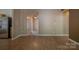 Open floor plan showcasing the living room and entryway with wood-look flooring at 6808 Squirrels Foot Ct, Charlotte, NC 28217