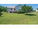 Backyard of house with manicured lawn, AC unit and mature shade trees at 727 Skinner Rd, Shelby, NC 28152