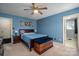 A carpeted bedroom with blue walls and a ceiling fan at 727 Skinner Rd, Shelby, NC 28152