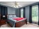 Comfortable bedroom features a bed, two windows, and neutral gray walls with dark curtains at 727 Skinner Rd, Shelby, NC 28152