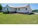 Rear view of house with well-maintained lawn, back door and garage entrance at 727 Skinner Rd, Shelby, NC 28152