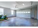 Well-lit garage featuring an automatic door, ample storage space and a lawn tractor at 727 Skinner Rd, Shelby, NC 28152