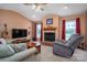 Bright living room with cozy fireplace, comfortable seating, and natural light at 727 Skinner Rd, Shelby, NC 28152