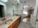 Well-lit bathroom with a double sink vanity, large mirror, and separate tub and shower at 944 Evian Ln, Matthews, NC 28015