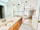Bathroom featuring a double vanity, large mirror, and a step-up jacuzzi tub/shower room at 944 Evian Ln, Matthews, NC 28015