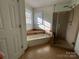 Bathroom featuring a combination tub and shower with tiled surround and a window at 944 Evian Ln, Matthews, NC 28015