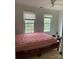 Bedroom filled with natural light showcases dual windows, and neutral paint at 944 Evian Ln, Matthews, NC 28015