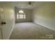 Cozy bedroom offers carpeted flooring and a window allowing natural light to flow in at 944 Evian Ln, Matthews, NC 28015