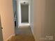 Hallway featuring carpet floors and access to various rooms at 944 Evian Ln, Matthews, NC 28015