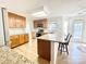 Well-lit kitchen features granite countertops, wood cabinets, and modern appliances at 944 Evian Ln, Matthews, NC 28015