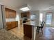 Open kitchen has granite countertops, wooden cabinets and stainless steel appliances at 944 Evian Ln, Matthews, NC 28015