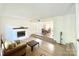 Open concept living room features hardwood floors, fireplace, and seamless flow to dining area at 944 Evian Ln, Matthews, NC 28015