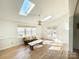 Bright living space with skylights, ceiling fan, hardwood floors, and access to the outdoors at 944 Evian Ln, Matthews, NC 28015