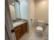 Neat half bath features a wooden vanity, granite countertop, and marble floors at 944 Evian Ln, Matthews, NC 28015