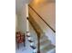 Carpeted staircase with wooden railings and white spindles, providing a classic and elegant transition between floors at 944 Evian Ln, Matthews, NC 28015