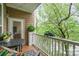 A balcony overlooking lush greenery with a table and chairs for outdoor enjoyment at 1000 E Woodlawn Rd # 315, Charlotte, NC 28209