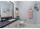 Bathroom featuring framed mirror, hexagon decor, and light gray walls at 1000 E Woodlawn Rd # 315, Charlotte, NC 28209