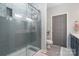 Bathroom with gray tiled shower, white walls, and sleek fixtures at 1000 E Woodlawn Rd # 315, Charlotte, NC 28209