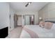 Spacious bedroom with ceiling fan, large window, and convenient access to the bathroom at 1000 E Woodlawn Rd # 315, Charlotte, NC 28209