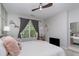 Bright bedroom with large window, ceiling fan, and comfortable decor at 1000 E Woodlawn Rd # 315, Charlotte, NC 28209