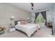 Cozy bedroom features a ceiling fan, large window, and modern furnishings at 1000 E Woodlawn Rd # 315, Charlotte, NC 28209