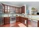Well-equipped kitchen featuring wood cabinets, stainless steel appliances, and granite countertops at 1000 E Woodlawn Rd # 315, Charlotte, NC 28209