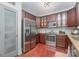 Modern kitchen featuring stainless steel appliances, wood floors, and glass-front cabinets at 1000 E Woodlawn Rd # 315, Charlotte, NC 28209