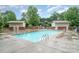A community pool with lounging area surrounded by greenery, perfect for relaxing and recreation at 1000 E Woodlawn Rd # 315, Charlotte, NC 28209