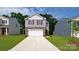 Charming two-story home with a stone facade and a two-car garage, surrounded by lush greenery at 1007 20Th Avenue Se Loop, Hickory, NC 28602