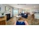 Open concept living area showcasing a fireplace, kitchen with granite countertops, and wood flooring at 1007 20Th Avenue Se Loop, Hickory, NC 28602