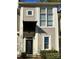 Charming townhouse featuring a covered entryway, large windows, and neutral siding for a modern aesthetic at 1049 Park West Dr, Charlotte, NC 28209