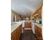 Functional kitchen with wood cabinets, white appliances, and hardwood floors extending into the open floor plan at 1049 Park West Dr, Charlotte, NC 28209