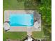 Aerial view of a backyard pool, landscaping, patio, and manicured lawn at 105 Walnut Hill Ct, Mooresville, NC 28115