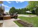 The backyard has a barbecue grill, pool, and patio with lots of green vegetation at 105 Walnut Hill Ct, Mooresville, NC 28115