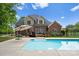 Backyard featuring a pool, spacious patio, and outdoor seating area, perfect for entertaining at 105 Walnut Hill Ct, Mooresville, NC 28115