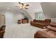 A finished basement features a plush sofa, mini bar and a ceiling fan at 105 Walnut Hill Ct, Mooresville, NC 28115