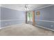 Bright bedroom with a ceiling fan, window with blinds, and neutral carpeting at 105 Walnut Hill Ct, Mooresville, NC 28115