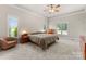 Bright main bedroom with neutral tones, carpet flooring, and large windows at 105 Walnut Hill Ct, Mooresville, NC 28115