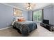 This sunlit bedroom is bright with a beautiful window and ceiling fan at 105 Walnut Hill Ct, Mooresville, NC 28115